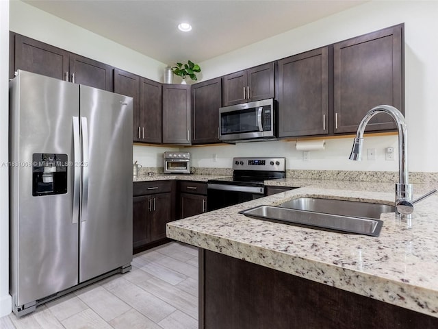 4923 NW 48th Ter, Tamarac, FL 33319 - kitchen with appliances with stainless steel finishes, dark brown cabinetry, and recessed lighting