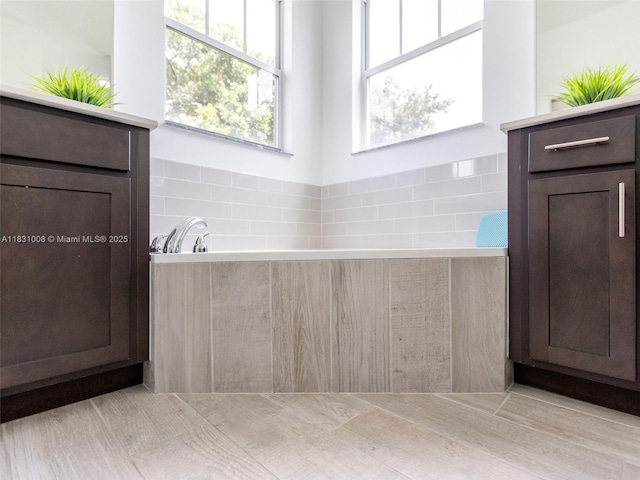 4923 NW 48th Ter, Tamarac, FL 33319 - bathroom featuring a garden tub and tasteful backsplash