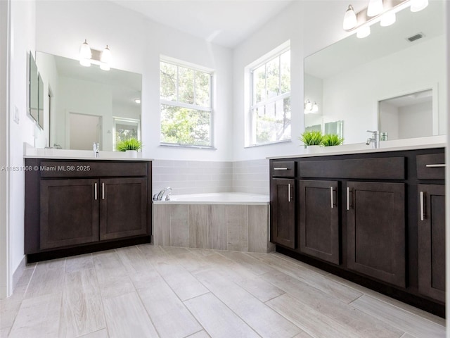4923 NW 48th Ter, Tamarac, FL 33319 - bathroom featuring two vanities and a bath