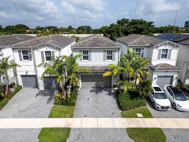 4923 NW 48th Ter, Tamarac, FL 33319 - view of front facade with a garage, driveway, a residential view, and stucco siding