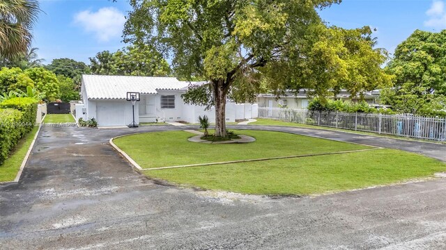201 S Biscayne River Dr, Miami, FL 33169 - view of front of home featuring curved driveway, stucco siding, and a tiled roof