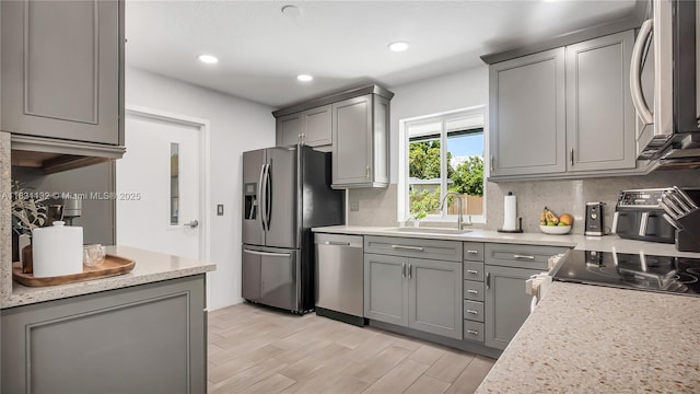 10401 NW 21st St, Pembroke Pines, FL 33026 - kitchen featuring stainless steel appliances, gray cabinets, light wood-style flooring, and recessed lighting