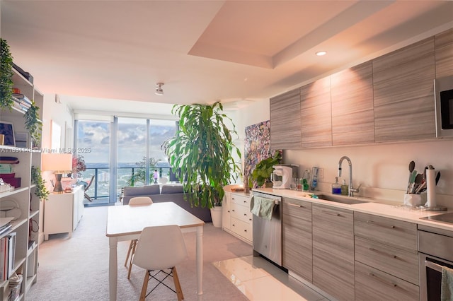 121 NE 34th St Unit 3110, Miami, FL 33137 - kitchen featuring appliances with stainless steel finishes, modern cabinets, light countertops, recessed lighting, and light carpet
