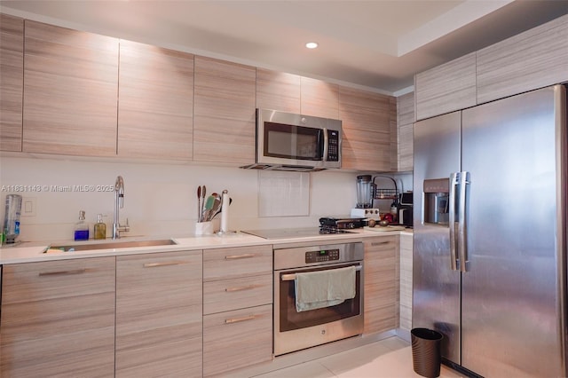 121 NE 34th St Unit 3110, Miami, FL 33137 - kitchen with appliances with stainless steel finishes, modern cabinets, light countertops, recessed lighting, and light brown cabinetry