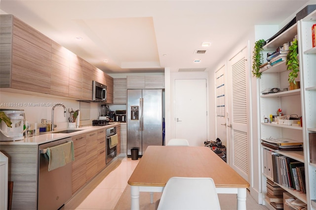 121 NE 34th St Unit 3110, Miami, FL 33137 - kitchen featuring stainless steel appliances, modern cabinets, light countertops, open shelves, and light tile patterned floors