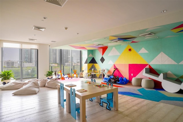 121 NE 34th St Unit 3110, Miami, FL 33137 - playroom featuring hardwood / wood-style floors and a wall of windows