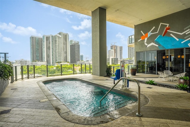 121 NE 34th St Unit 3110, Miami, FL 33137 - view of swimming pool with a skyline view, a swimming pool, and a patio area