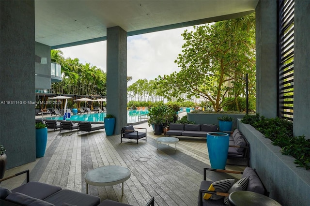 121 NE 34th St Unit 3110, Miami, FL 33137 - wooden terrace with a community pool and an outdoor living space