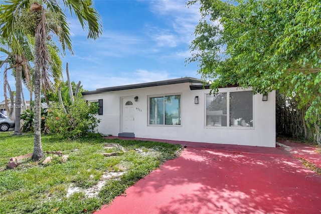 4917 SW 43rd Ter, Dania Beach, FL 33314 - view of front facade featuring stucco siding and a front lawn