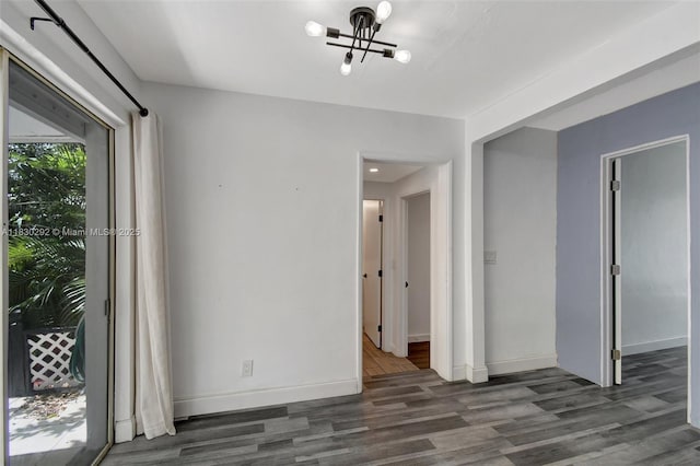4917 SW 43rd Ter, Dania Beach, FL 33314 - unfurnished room with a chandelier and wood finished floors