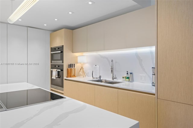 2301 Collins Ave Unit 407, Miami Beach, FL 33139 - kitchen with black electric cooktop, light brown cabinets, light countertops, and stainless steel double oven
