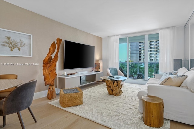 2301 Collins Ave Unit 407, Miami Beach, FL 33139 - living room featuring wood finished floors and a wall of windows