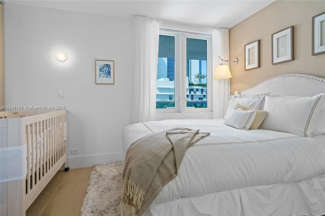 2301 Collins Ave Unit 407, Miami Beach, FL 33139 - bedroom featuring baseboards and wood finished floors