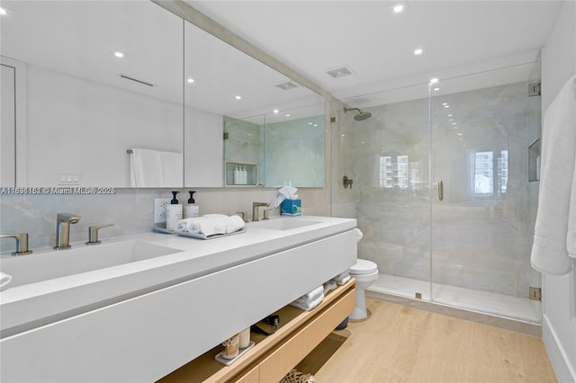 2301 Collins Ave Unit 407, Miami Beach, FL 33139 - full bathroom with double vanity, a shower stall, wood finished floors, and recessed lighting