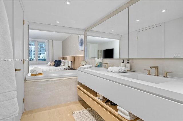 2301 Collins Ave Unit 407, Miami Beach, FL 33139 - full bath featuring double vanity, connected bathroom, wood finished floors, and recessed lighting
