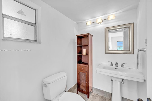 4141 Nautilus Dr Unit 7J, Miami Beach, FL 33140 - half bathroom featuring toilet and wood finished floors