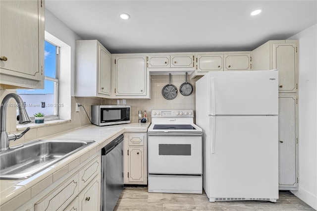 4141 Nautilus Dr Unit 7J, Miami Beach, FL 33140 - kitchen with appliances with stainless steel finishes, tasteful backsplash, recessed lighting, light wood-type flooring, and tile countertops