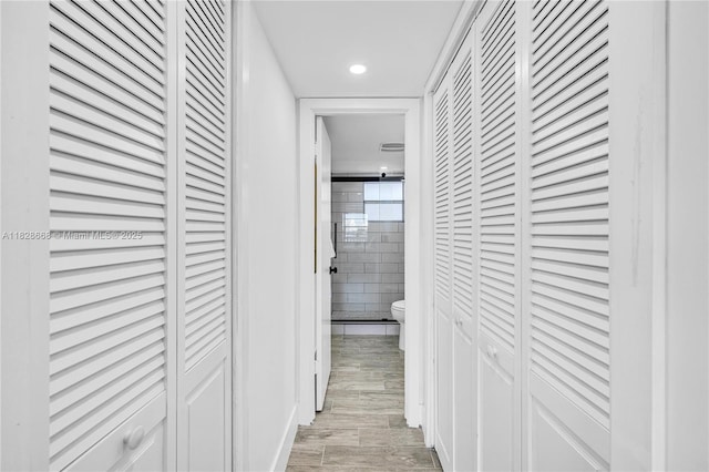 4141 Nautilus Dr Unit 7J, Miami Beach, FL 33140 - corridor with tile walls, light wood finished floors, and recessed lighting