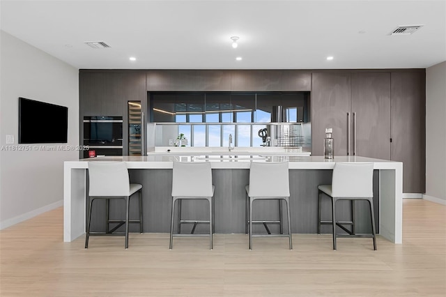 851 NE 1st Ave Unit Ph4912, Miami, FL 33132 - kitchen featuring modern cabinets, light wood-type flooring, light countertops, and recessed lighting