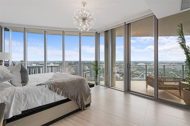851 NE 1st Ave Unit Ph4912, Miami, FL 33132 - bedroom featuring floor to ceiling windows, access to outside, a chandelier, and wood finished floors