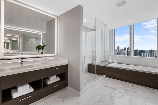 851 NE 1st Ave Unit Ph4912, Miami, FL 33132 - full bathroom featuring marble finish floors, a garden tub, vanity, a stall shower, and a skyline view
