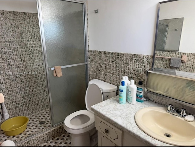 11685 Canal Dr Unit 303, North Miami, FL 33181 - bathroom with tile walls, a shower stall, vanity, and a wainscoted wall