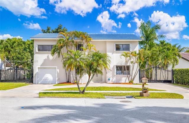 15235 SW 99th Ct, Miami, FL 33157 - view of front of home with concrete driveway, a gate, a garage, a tiled roof, and stucco siding