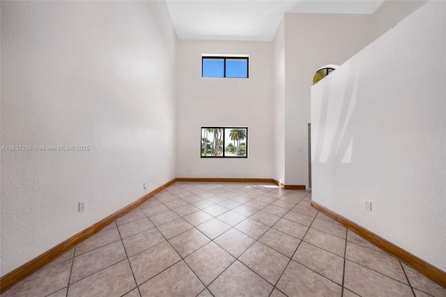 15235 SW 99th Ct, Miami, FL 33157 - empty room featuring light tile patterned floors and a towering ceiling
