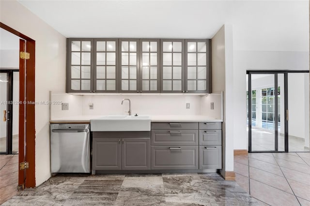 15235 SW 99th Ct, Miami, FL 33157 - kitchen featuring stainless steel dishwasher, gray cabinetry, glass insert cabinets, and light countertops