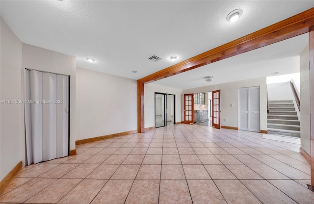 15235 SW 99th Ct, Miami, FL 33157 - unfurnished living room featuring stairs, a textured ceiling, and light tile patterned flooring