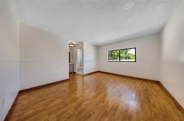 15235 SW 99th Ct, Miami, FL 33157 - spare room with light wood-style flooring and a textured ceiling