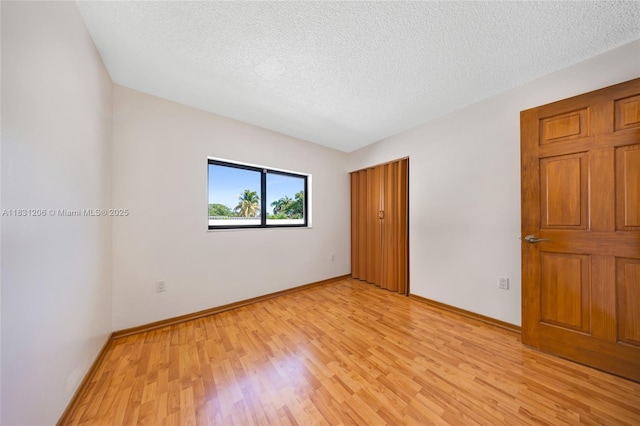 15235 SW 99th Ct, Miami, FL 33157 - spare room featuring light wood finished floors and a textured ceiling