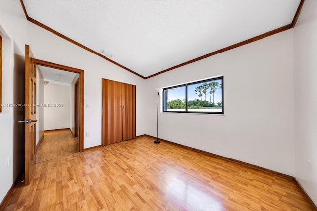 15235 SW 99th Ct, Miami, FL 33157 - unfurnished bedroom with vaulted ceiling, ornamental molding, light wood-type flooring, and a closet