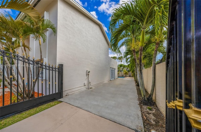 15235 SW 99th Ct, Miami, FL 33157 - view of side of home featuring stucco siding and a patio area