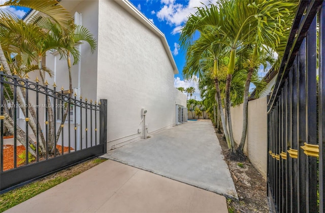 15235 SW 99th Ct, Miami, FL 33157 - view of side of home featuring stucco siding and a patio area