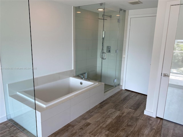 650 NE 32nd St Unit 802, Miami, FL 33137 - full bath featuring a shower stall, a garden tub, and wood finished floors