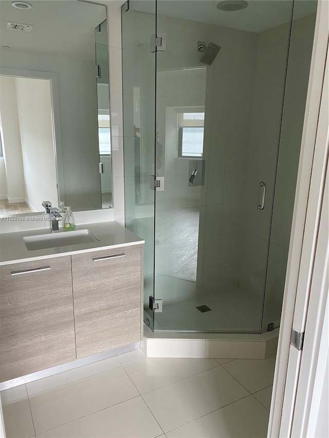 650 NE 32nd St Unit 802, Miami, FL 33137 - bathroom featuring vanity, a stall shower, and tile patterned floors