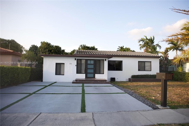771 E 35th St, Hialeah, FL 33013 - view of front of home with stucco siding, a tile roof, and concrete driveway