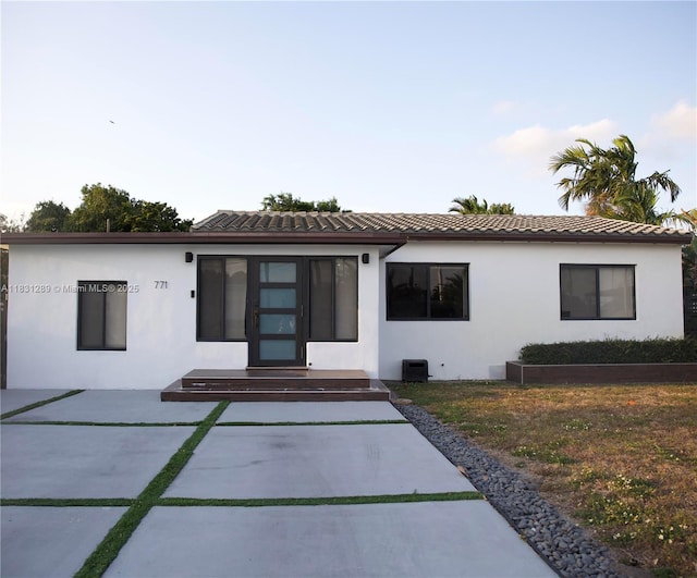 771 E 35th St, Hialeah, FL 33013 - rear view of property featuring stucco siding and a tile roof