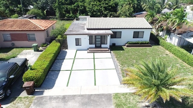 771 E 35th St, Hialeah, FL 33013 - rear view of property featuring stucco siding, concrete driveway, and a tile roof