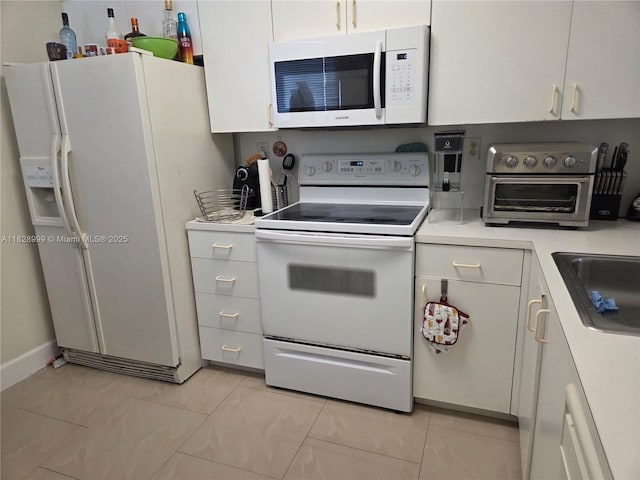 4720 NW 114th Ave Unit 206, Doral, FL 33178 - kitchen featuring white appliances, light countertops, and white cabinets