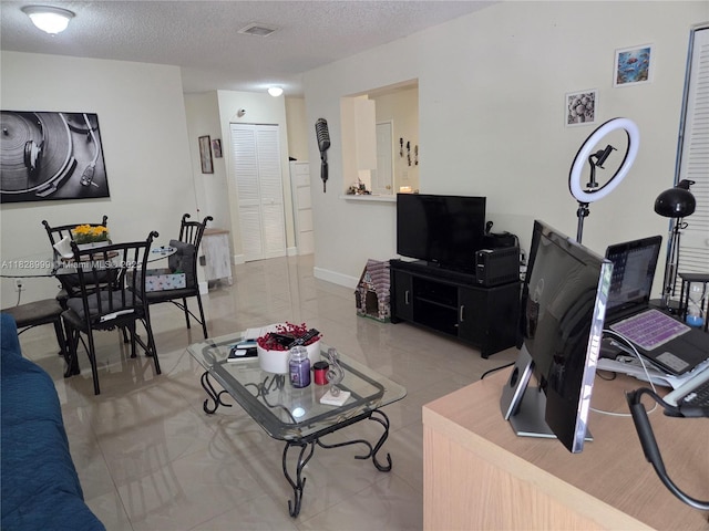 4720 NW 114th Ave Unit 206, Doral, FL 33178 - living area with a textured ceiling and light tile patterned floors