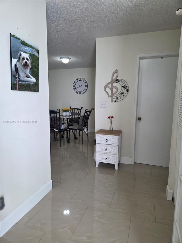4720 NW 114th Ave Unit 206, Doral, FL 33178 - hallway with baseboards and a textured ceiling