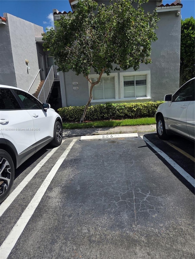 4720 NW 114th Ave Unit 206, Doral, FL 33178 - uncovered parking lot featuring stairway