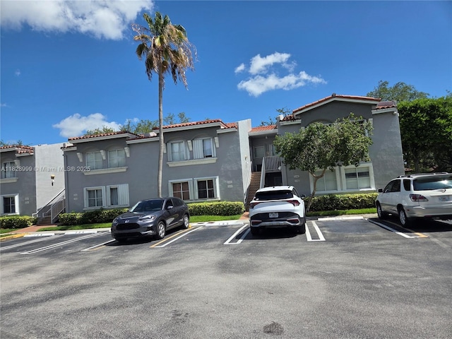 4720 NW 114th Ave Unit 206, Doral, FL 33178 - view of building exterior with uncovered parking and stairs