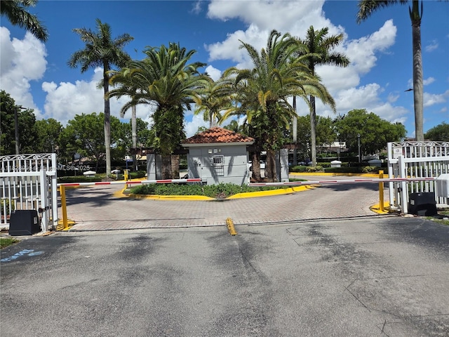 4720 NW 114th Ave Unit 206, Doral, FL 33178 - view of asphalt road featuring a gated entry and curbs