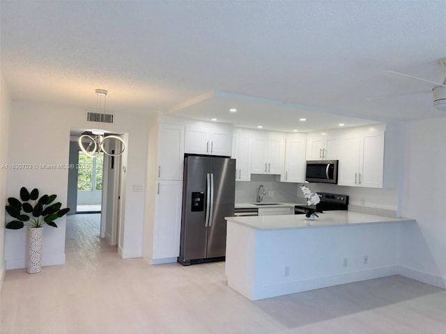 4025 Ellesmere B 4025, Deerfield Beach, FL 33442 - kitchen with appliances with stainless steel finishes, light countertops, a peninsula, white cabinetry, and recessed lighting