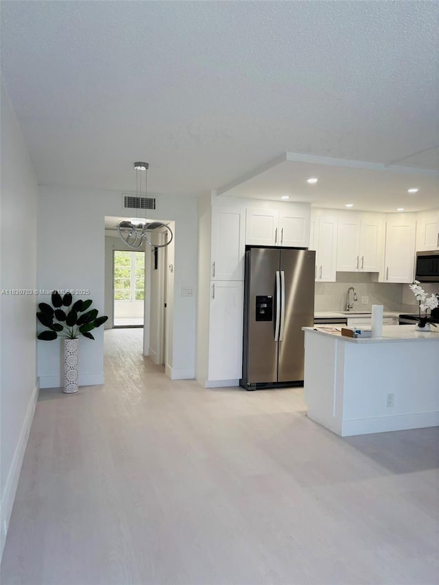 4025 Ellesmere B 4025, Deerfield Beach, FL 33442 - kitchen featuring appliances with stainless steel finishes, white cabinets, recessed lighting, light countertops, and light wood-style flooring