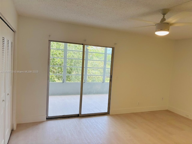 4025 Ellesmere B 4025, Deerfield Beach, FL 33442 - empty room featuring light wood finished floors, a ceiling fan, and a textured ceiling