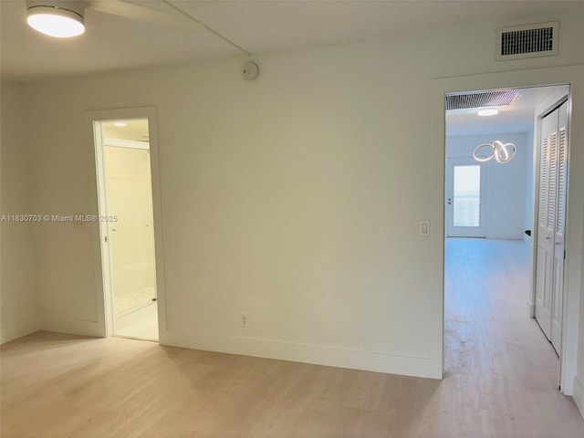 4025 Ellesmere B 4025, Deerfield Beach, FL 33442 - empty room with light wood-type flooring and a smoke detector